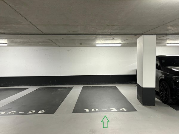 Overdekte parkeerplaats voorzien van camera bewaking in de parkeergarage van het Miles/Django-complex aan de Zuidas.